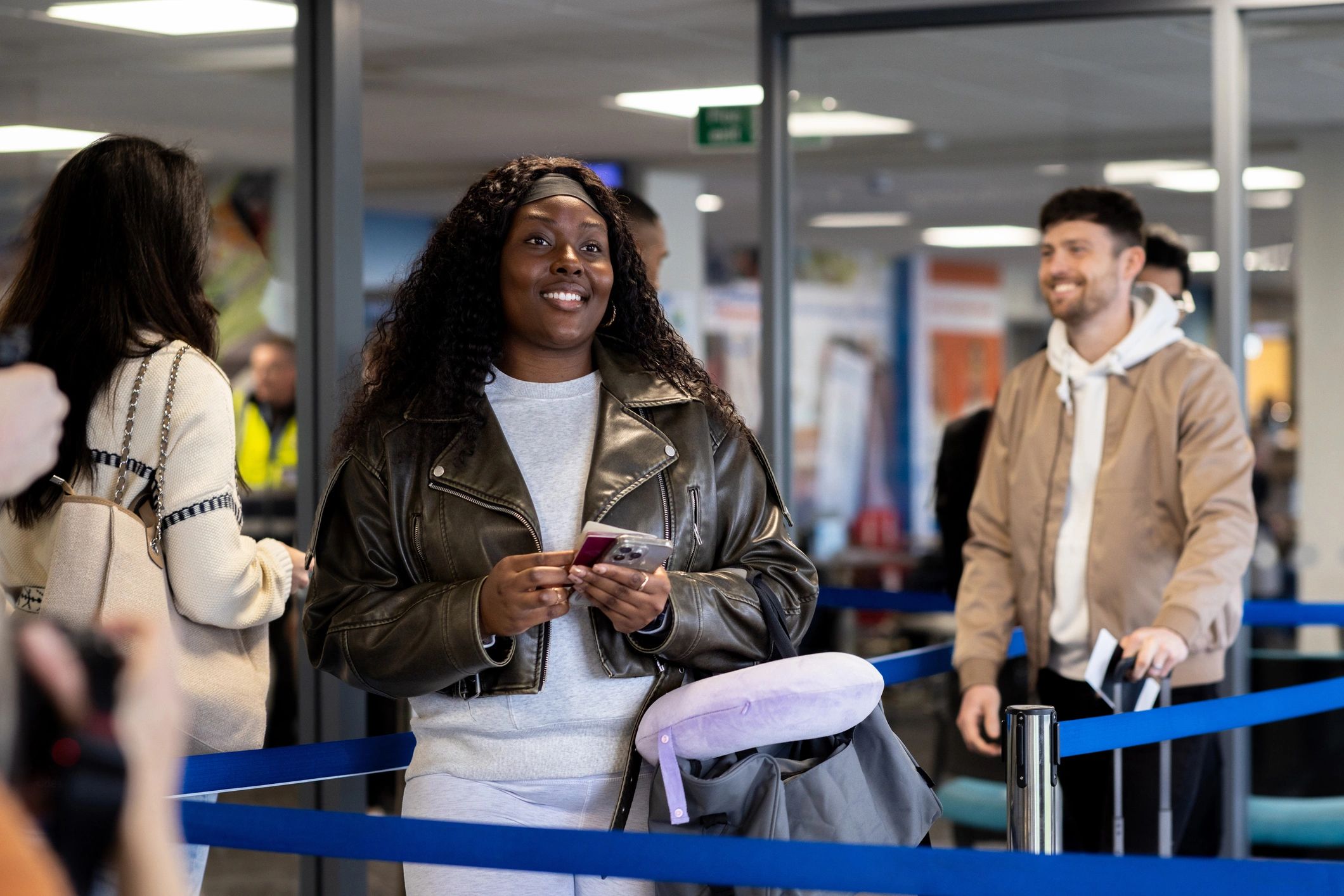 Travelers waiting in line at an airline check-in desk